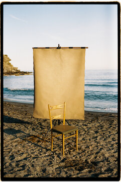 Portable studio setup on a beach with chair