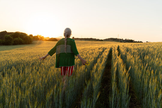 Senior Woman Walking At Sunset