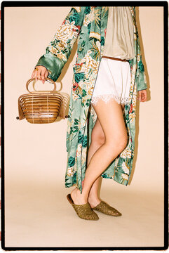 Woman wearing floral kimono robe and bamboo bag