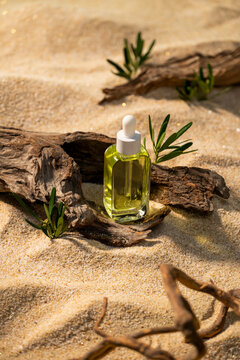 Natural serum bottle with dropper on driftwood amidst sandy beach
