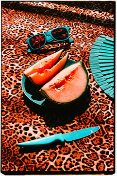 melon wedges on a blue plate and leopard print, 35mm film