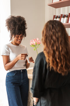 Anonymous Woman Consulting With Retail Associate Over Skincare 