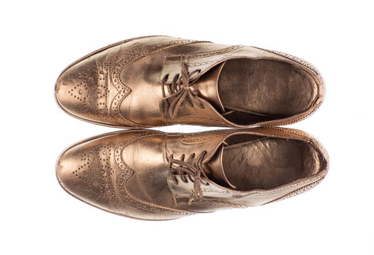 Golden men's shoes isolated on white background