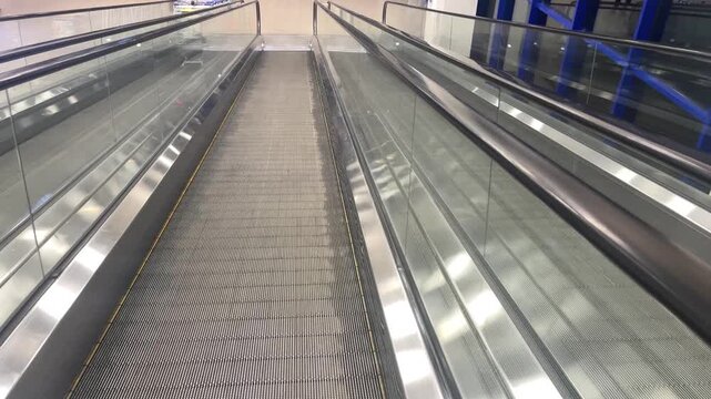 an escalator moving down in a shopping mall. High quality 4k footage