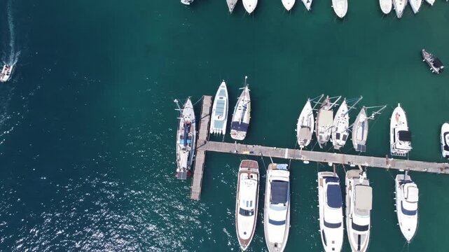 Aerial top-down view of docked sailboats. Top down view of yachts. High quality 4k footage