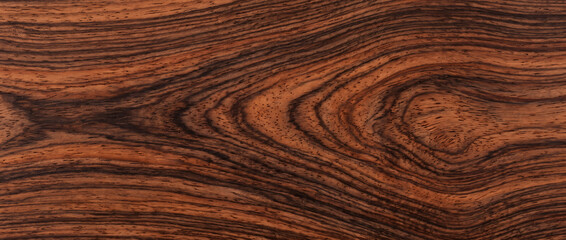 Obraz premium Rosewood wood texture with deep reddish brown natural grain seamless exotic hardwood background