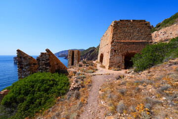 Fototapeta premium Historic ruins of the Laveria Lamarmora mining complex perched on the cliffs of Nebida, Sardinia, Italy
