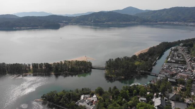 Aerial drone shot of Kaisenkyo rotating bridge and town in Amanohashidate, Kyoto, Japan