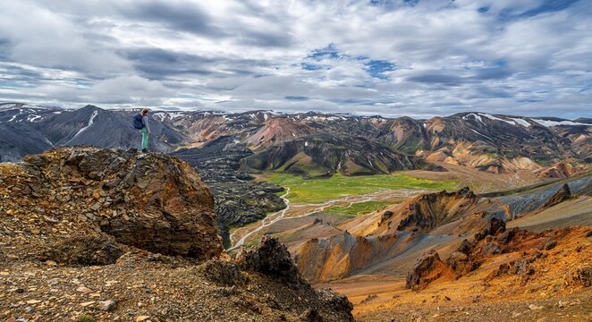 Hiker on the trekking trail Laugavegur, Trekking trail Laugavegur, Dramatic volcanic landscape, Colourful erosion landscape with mountains, Lava field, Landmannalaugar, Fjallabak nature reserve, Su&eth;urland, Iceland