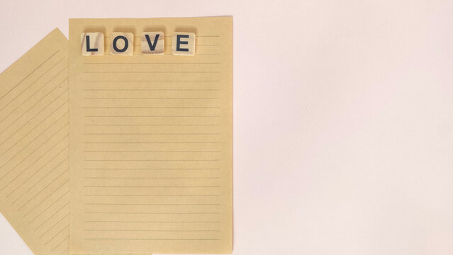Love word on lined letter paper isolated on white background with copy space for romantic message