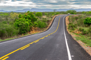 Naklejka premium Scenic Paved Road Crossing the Semiarid Caatinga Landscape in the Sertao of Paraiba, Northeast Brazil