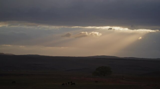 Timelapse of shafts of sun rays and clouds as a storm approaches near Torrey, Utah