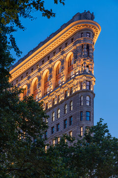 New York City, NY, USA - July 1st, 2026: Flatiron Building at dusk with newly illuminated facade. Flatiron District (Broadway and Fifth Avenue), Manhattan