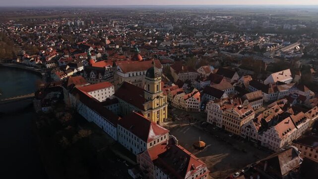 Bird eye view of the iconic Catholic Church of Our Lady and red rooftop street grid in Neuburg an der Donau creating a beautiful skyline panorama of the ancient residential city