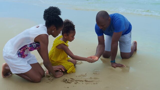 Beach family, black joyful man and child on summer coastline, kneeling on wet sand to find tiny seashell, warm waves and gentle light, heart traced in shore, tender bonding, calm ocean play