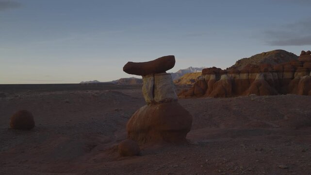 An aerial flyover sandstone rock formation and hoodoos at sunrise, Little Egypt, Utah