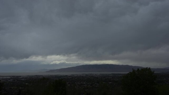 A timelapse of clouds and an approaching storm moving over Utah Valley and Utah Lake, Cedar Hills, UT
