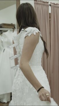 A young woman is trying on wedding dresses, vertical video, St. George, Utah
