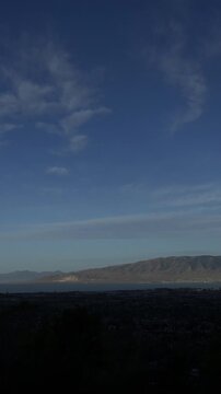 A vertical video timelapse of the beginning of a day, overlooking Utah Valley and Utah Lake, Cedar Hills, UT