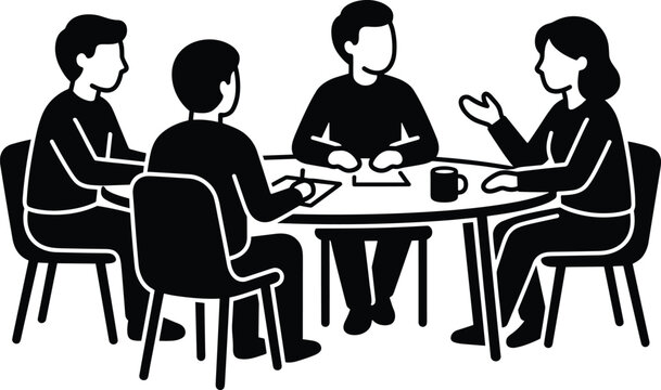 Four people sitting around a table in a meeting or discussion