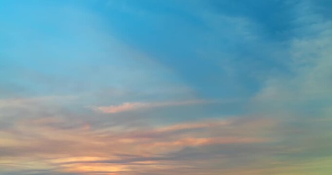 Time lapse of beautiful clouds with soft pastel colors at sunset