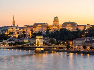 Fototapeta premium Budapest castle hill illuminated at dusk with chain bridge and danube river view.