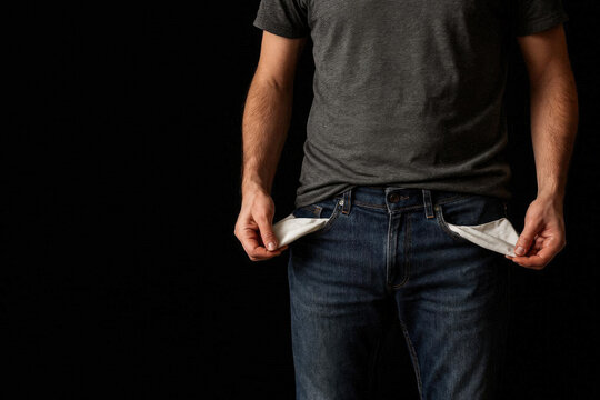 Man showing empty pockets on black background. Space for text.
