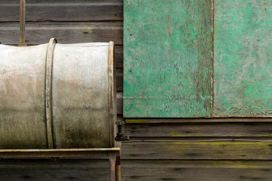 Canada, BC, Richmond.  Rustic detail of steel storage tank and weathered siding.