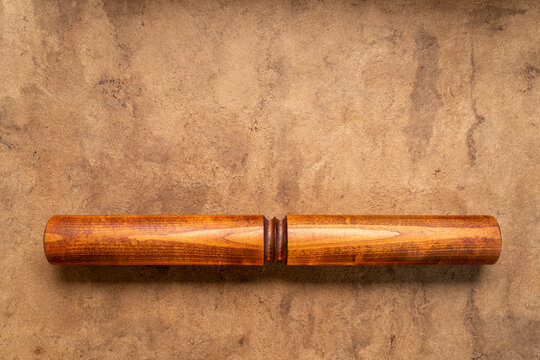Wooden Tai Chi ruler, a  traditional Chinese exercise tool, on textured bark paper