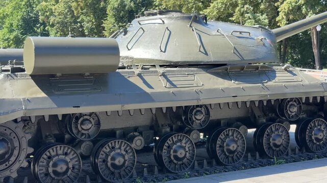 Armored Giant: A detailed, close-up view of a military tank's tracks and turret, showcasing its robust construction and formidable presence, hinting at its historical significance.