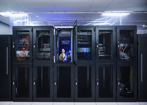 Asian Female Cybersecurity Professional Working in Data Center