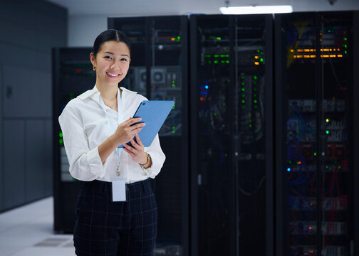 Female Technology Specialist Standing in Server Room