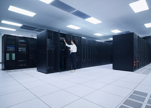 Asian Woman Managing Cloud Infrastructure in Data Center