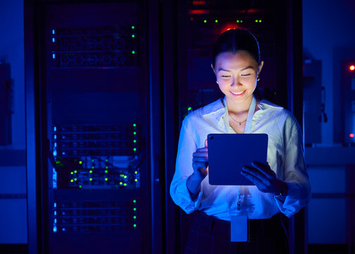 Female IT Professional working on Tablet in Server Room