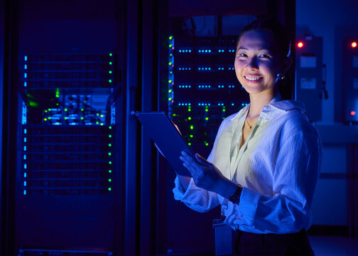 Asian Woman Managing Cloud Infrastructure in Data Center