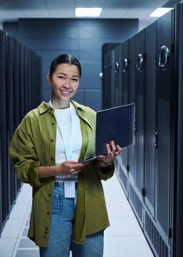 Female Technology Specialist Standing in Server Room