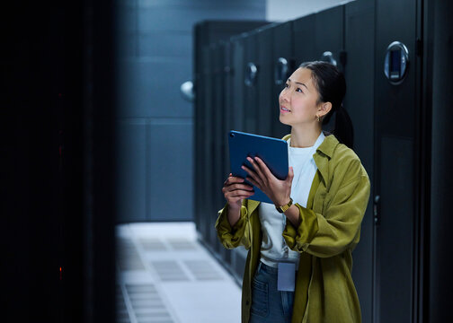 Female IT Professional Reviewing Infrastructure on Tablet