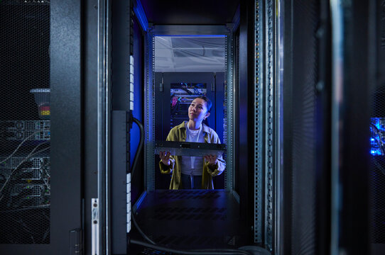 Asian Woman Managing Cloud Infrastructure in Data Center