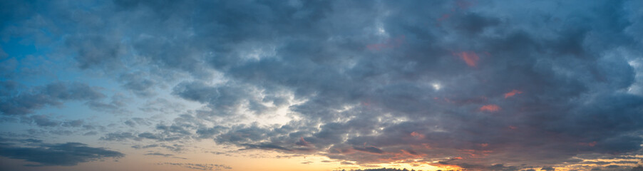 Obraz premium Panorama of a colorful clouds lit with sunset colors. Only the clouds are included in frame.