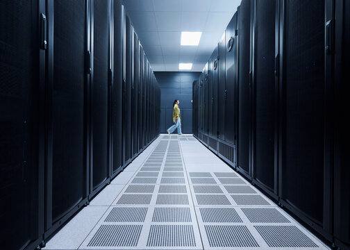 Female Cybersecurity Professional Working in Data Center