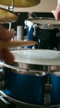 Close up drummer playing jazz rhythm on snare drum, high tom and hi hat with wooden sticks. Professional jazz percussion performance. Drummer playing jazz on drums in music studio. Vertical video