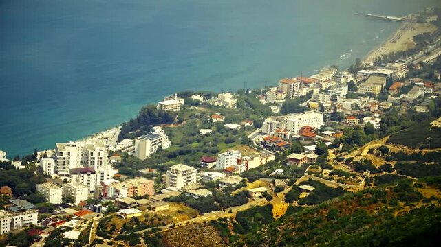 Aerial View Of Coastal Resort Town On Hillside Near Blue Sea. Mediterranean City Architecture Buildings. Summer Vacation