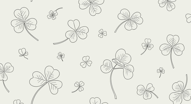 Seamless outline pattern of hand-drawn black and white shamrocks and four-leaf clovers for Saint Patricks Day.