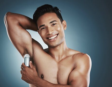 Confident man applying roll-on deodorant for daily freshness and body care