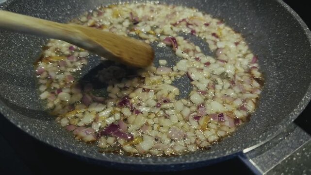Saut&eacute;ing Stirring Finely Chopped Onion In Frying Pan In Hot Oil