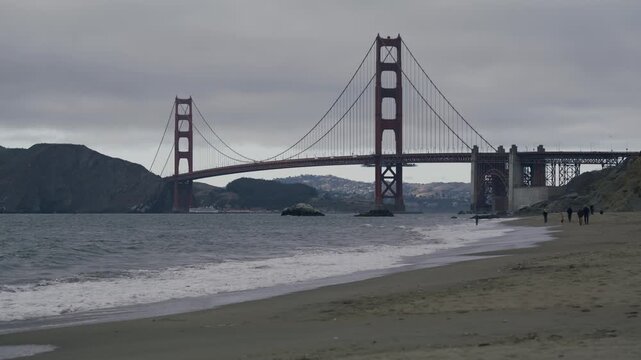 San Francisco Golden Gate Bridge Beach With Silhouetted People Walking On Stormy Day