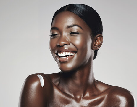 Smiling Beautiful Black Woman with Glowing Skin and Body Lotion on Shoulder