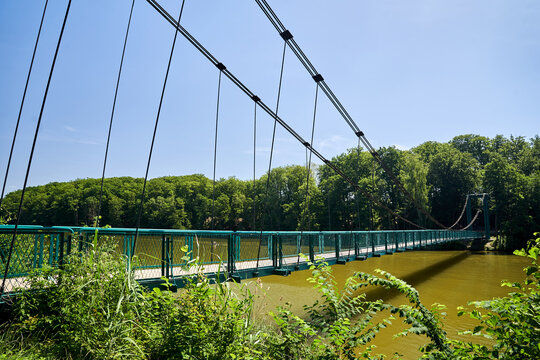 Pedestrian and cyclist suspension bridge over Lake Radun in Walcz