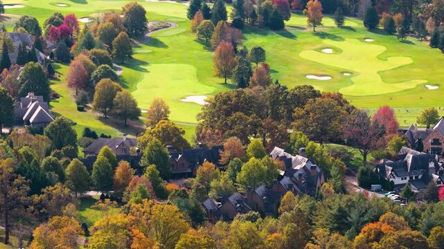 Beautiful mountain residences near Asheville, North Carolina nestled among colorful autumn trees. Peaceful hillside community surrounded by scenic woodland.