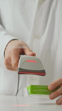 Young Caucasian pharmacist, acting as pharmacy specialist, attentively operates equipment at pharmacy counter, handling medicine, dispensing prescriptions, and assisting client in healthcare setting